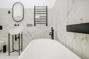 toilet and detail of a corner shower cabin with wall mount shower attachment photo