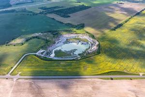 ariel top view of an old flooded lime quarry with turquoise water photo