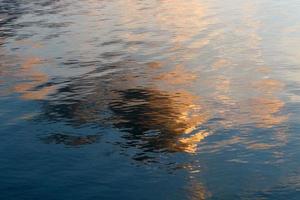 Sunrise on the shore of the Dead Sea in Israel. The sun rises from behind the mountains in Jordan. photo