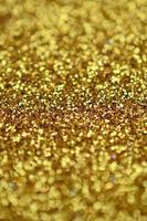 A huge amount of yellow decorative sequins. Background texture with shiny, small elements that reflect light in a random order. Glitter texture photo