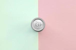 Metallic beer can on texture background of fashion pastel turquoise and pink colors photo