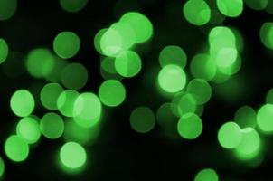 Green abstract Christmas blurred luminous background. Defocused artistic bokeh lights image photo