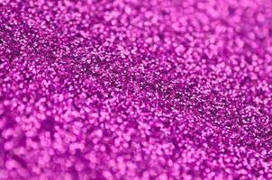 Pink decorative sequins. Background image with shiny bokeh lights from small elements photo