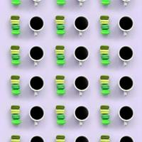 A pattern of many colorful dessert cake macaroon and coffee cups on trendy pastel lilac background top view photo