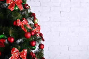 Detailed photo of the Christmas tree on white brick wall