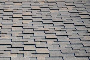 Modern roofing and decoration of chimneys. Flexible bitumen or slate shingles photo