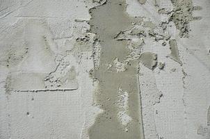 The texture of the wall, covered with gray foam polystyrene plates, which are smeared with a reinforcing mixture. Stage of wall insulation photo