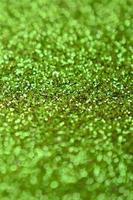 Lime green decorative sequins. Background image with shiny bokeh lights from small elements