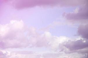 A blue sky with lots of white clouds of different sizes photo