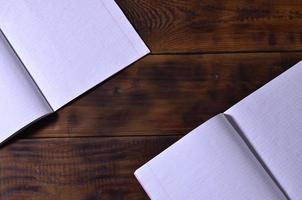 Photo of a clean white school checkbook on a brown wooden background. Idea or message concept. Plenty of space for text