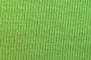 The texture of the fabric is bright green. Material for making shirts and blouses photo