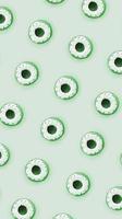 Many small plastic donuts lies on a pastel colorful background. Flat lay minimal pattern. Top view photo