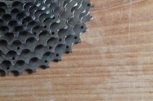 Rear cassette sprocket from a mountain bike lying on a wooden table in a bike shop photo