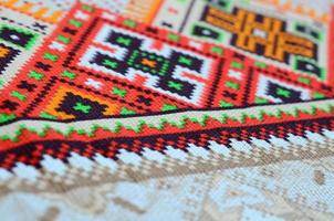 Traditional Ukrainian folk art knitted embroidery pattern on textile fabric photo