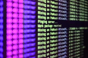 Macro snapshot of the program interface for crypto currency mining on the monitor of an office computer. The concept of mining bitcoins. The flow of information strings and data photo