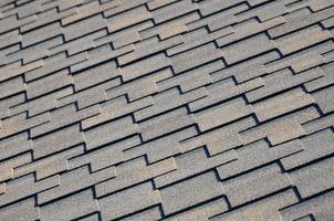 Modern roofing and decoration of chimneys. Flexible bitumen or slate shingles photo