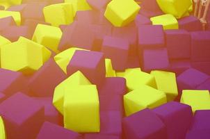 Many colorful soft blocks in a kids' ballpit at a playground photo