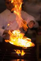 Chef doing flambe on food photo