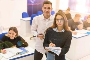 young students writing notes photo