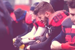 american football player holding the injured shoulder photo