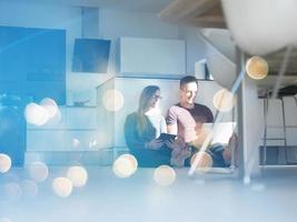 couple using tablet and laptop computers photo