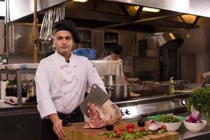 chef cutting big piece of beef photo