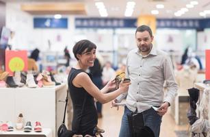 pareja elige zapatos en zapatería foto