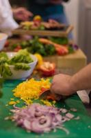 Chef cutting fresh and delicious vegetables photo