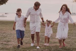 Senior couple in casual clothes with their children, boy and girl enjoy the beach spending a vacation together. Family time . Selective focus photo