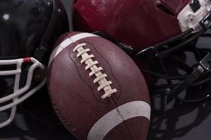 american football and helmets isolated on gray photo