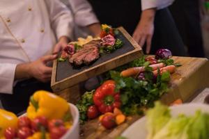 team cooks and chefs preparing meal photo