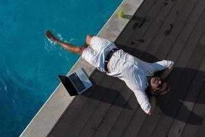 A modern senior man in casual clothes enjoys a vacation in an expensive house. Selective focus photo