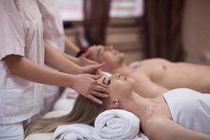 couple enjoying head massage at the spa photo