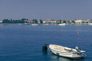 A photograph of a ship and a luxury yacht anchored in port. Beautiful photo of a Mediterranean port