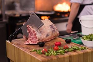 chef cutting big piece of beef photo