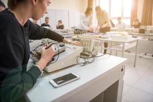 students doing practice in the electronic classroom photo