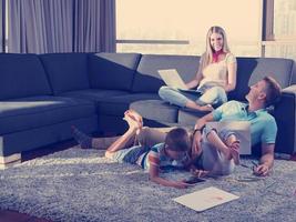 young couple spending time with kids at home photo