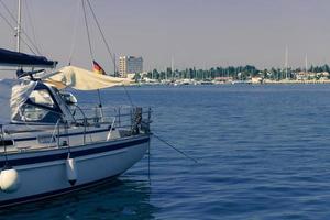 A photograph of a ship and a luxury yacht anchored in port. Beautiful photo of a Mediterranean port