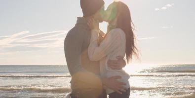 Couple having fun on beautiful autumn day at beach photo