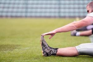 american football players stretching and warming up photo