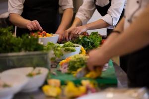 team cooks and chefs preparing meal photo