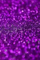 Purple decorative sequins. Background image with shiny bokeh lights from small elements photo