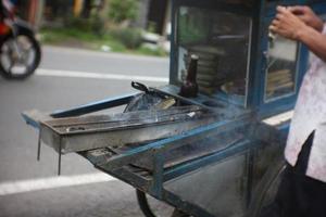 a special cart for selling chicken satay with wood base materials and blue paint photo