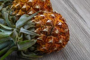 Small pineapple on wood photo