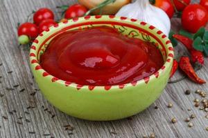 Tomato ketchup on wood photo