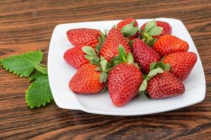 Fresh strawberry on wood photo