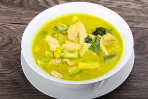 Green curry on wood photo