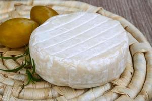 Brie cheese on wood photo