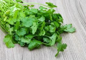 Coriander leaves on wood photo