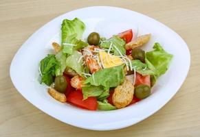 Caesar salad on wood photo